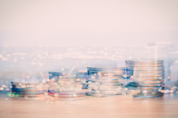 Double exposure of coins and city for business finance concept.
