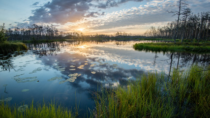 reflections in the lake water at sunrise