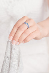 Woman hand with blue jewelry ring