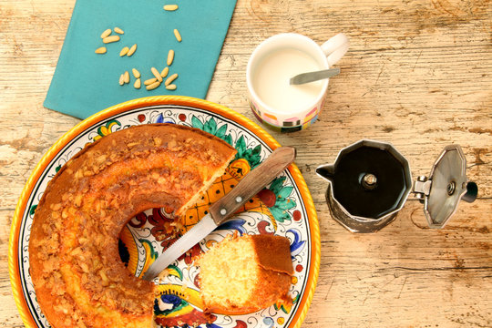 Breakfast with homemade ciambellone, a cup of milk and coffee.