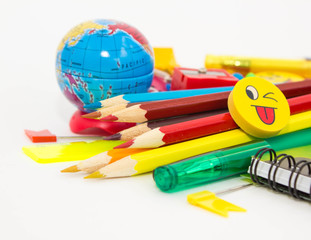 Pens, pencils, erasers with emoticons, a set of notebooks. Schoolchild and student studies accessories. Back to school concept.