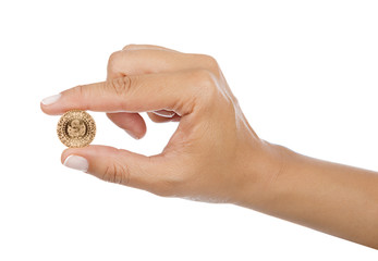 Turkish gold coin in between female fingers isolated 