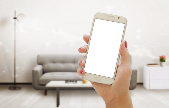 Modern smart phone with isolated screen for mockup in living room interior.