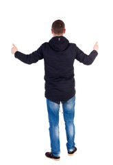 Back view of  man in jacket shows thumbs up.   Rear view people collection.  backside view of person.  Isolated over white background. A guy in a black jacket showing thumbs up with both hands.