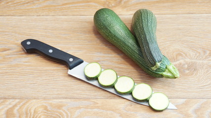 Sliced zucchini lying on a wooden table
