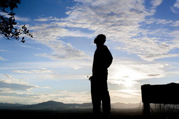 Silhouette people stand on cliff and sky background