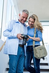 Happy mature couple holding camera