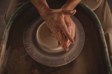 Male potter making pot