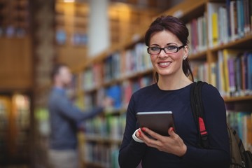 Portrait of mature student holding digital tablet