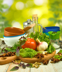 image of different herbs, tomato, oil, spices on the table