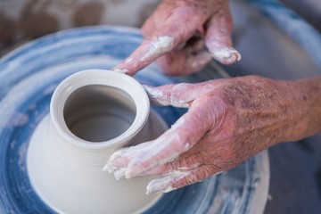 Obraz na płótnie Canvas Close-up of potter making pot