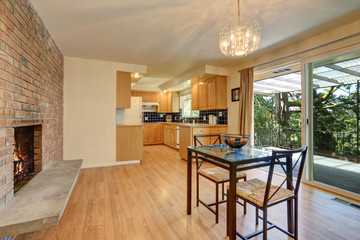 Nice dining room with hardwood floor and brick tile fireplace.