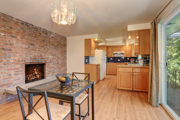 Nice dining room with hardwood floor and brick tile fireplace.