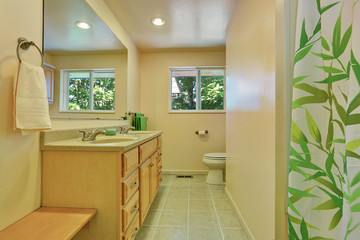 Bright bathroom with vanity cabinet and tile floor