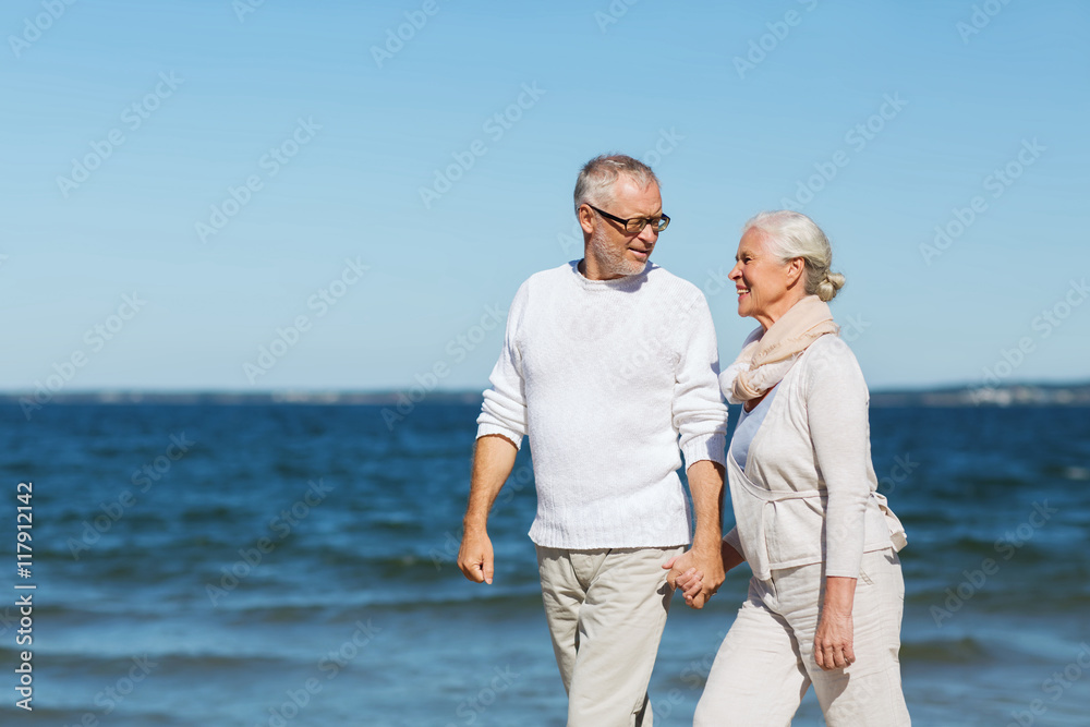 Poster happy senior couple holding hands on summer beach