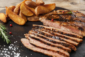 Beef steak sliced with baked potato and sauce