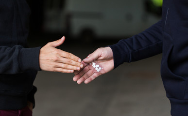 close up of addict buying dose from drug dealer