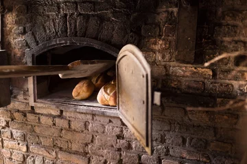 Zelfklevend Fotobehang Old brick kiln, with bread, in a bakery © Leandervasse
