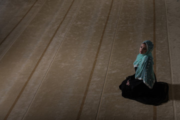 Young Woman Praying In The Mosque