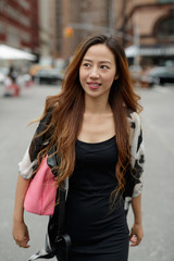 Fototapeta premium Young Asian woman in city walking smile happy face 