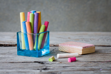 Colored chalks on wooden table, still life