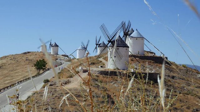Consuegra, Spain - June 2016: Tourists next to a windmills of Castilla la Mancha, Spain. Windmills at Consuegra