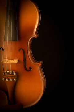 Close up of a violin isolated on black background
