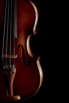 Close up of a violin isolated on black background