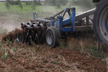 Loosening of the soil for sowing seed on agricultural farm. Close-up. Selective focus