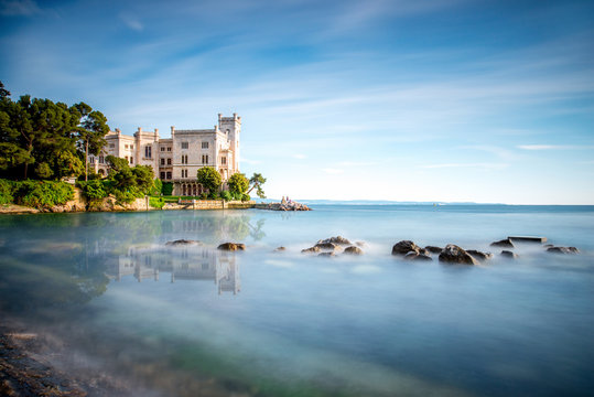 View on Miramare castle on the gulf of Trieste on northeastern Italy. Long exposure image technic with reflection on the water