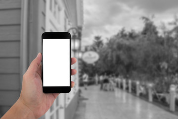 man hand holding the phone and white screen with blur black and