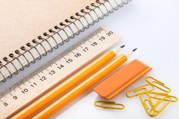notebook, eraser, ruler, pencil and paperclips