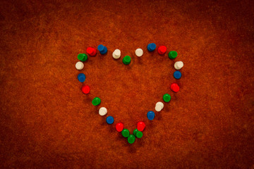 Board wood background, embroidery needle with an uninterrupted creative heart. themed concepts.