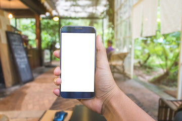 Close Up of Asian woman's hands using mobile phone and Coffee shop Laptop with blank copy space screen for your advertising text message or content, in the morning light.