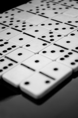 Black and white dominoes on the table