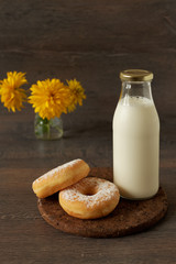 Morning breakfast with powdered sugar donuts and milk