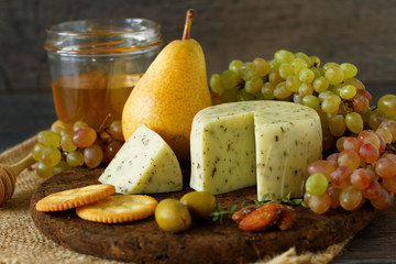 Various types of cheese, fruits and appetizers