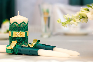 White wedding candles with green decoration