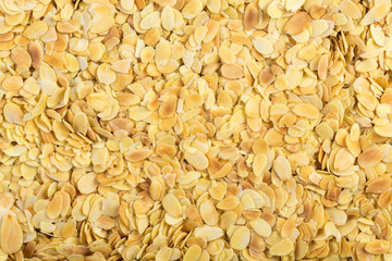 Chopped blanched almonds close-up photo.