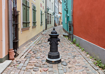 Narrow medieval street in old Riga that is the capital of Latvia and famous Baltic city known of its medieval architecture. 