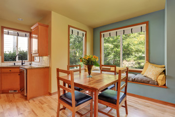 Dining area with wooden table set and cozy sitting place.