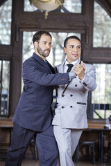 Partners Performing Scissors Step Of Argentine Tango