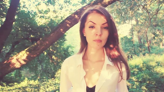 Sexy girl-Amazon, creative color correction. Standing in a beautiful forest, strong independent opinion, a great moment for the video. 
