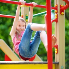 Fototapeta premium Cute little girl having fun on a playground