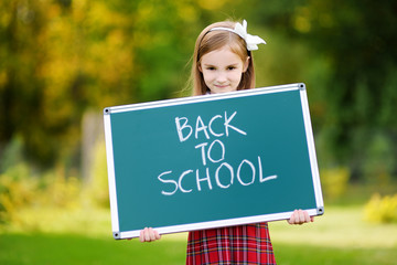 Adorable little girl feeling excited about going back to school