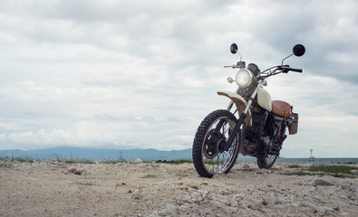 Fototapeta na wymiar Freedom.Motorbike under sky.Vintage photo effect added for create atmosphere