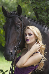 Fototapeta premium Outdoor portrait of a young girl and horse