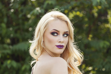outdoor portrait of fashion young beautiful woman with long blon