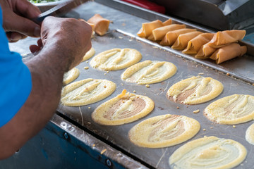 cooking rolling pancake (Khanom Tokyo) thin flat pancake filled with sweet custard cream