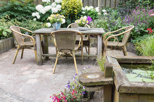 Wooden table and chairs in a ornamental garden